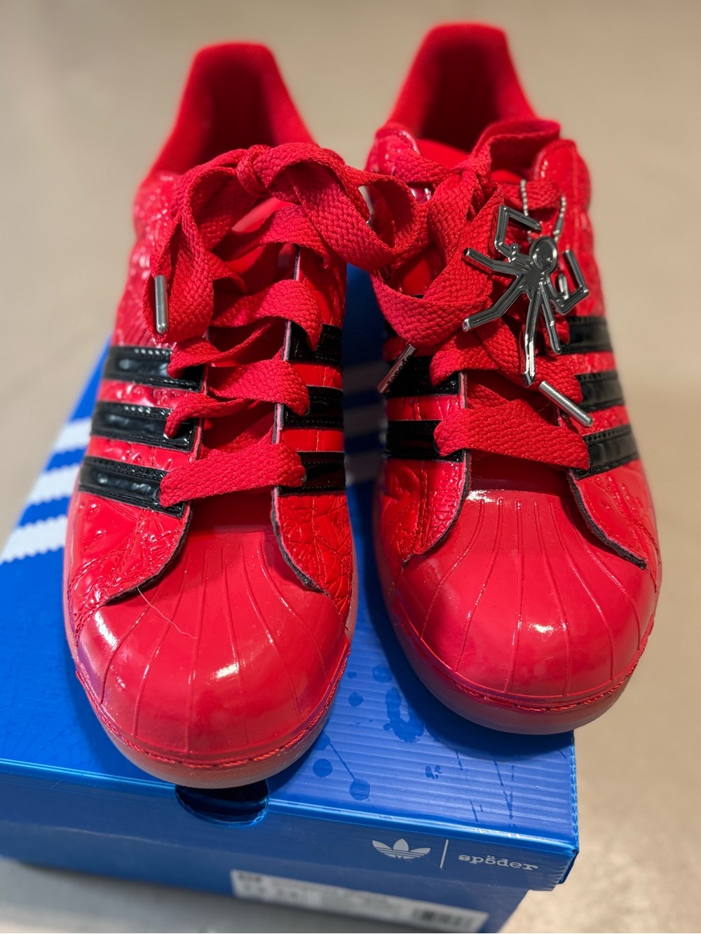 Red and black Sp5der x adidas Superstar sneakers